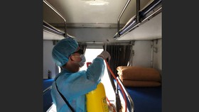 The worker disinfecting a train coach