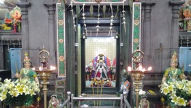 In the center is the shrine of the Goddess Mariamman and in a relief above the shrine the goddess is seated with the gods Ganesha and Naaga on either side.