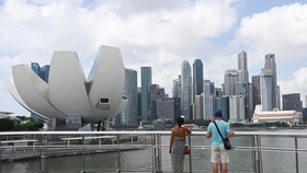 Tourists view the ArtScience Museum located within the integrated resort of Marina Bay Sands in Singapore (Photo: AFP)