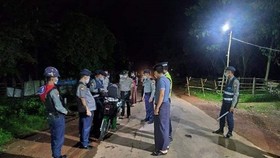 Police check a motorcycle in Yangon, Myanmar on 3 September after a curfew was imposed to prevent the spread of COVID-19. (Photo: gnlm.com.mm)