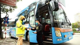 Tuần tra, kiểm soát đối với xe khách trên đường Phạm Hùng, quận Cầu Giấy. (Ảnh: Doãn Tấn/TTXVN)