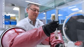 Doctor Philip Supply, Research Director for the CNRS, holds the original test tube containing the strain of Bacillus Calmette Guerin in France, on March 22. Photographer: Denis Charlet /AFP via Getty Images