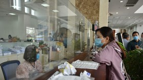 Hàng ngàn doanh nghiệp có thể bị phạt chậm nộp thuế nếu hiệu quả kinh doanh quý 4 tăng vượt trội so với các quý đầu năm. Trong ảnh: làm thủ tục thuế tại Cục Thuế TP.HCM - Ảnh: NGỌC PHƯỢNG