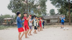 Children in Hue warm-up for football training. Photo Blue Dragon