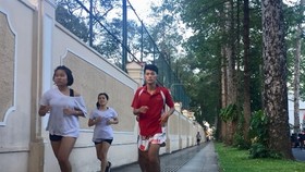 People exercise on pavement near the Independence Palace in HCM City’s District 1. (Photo: VNA)