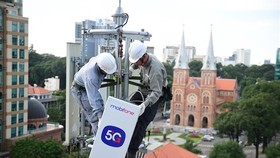 MobiFone's staff install equipment preparing for the launch of the 5G commercial pilot in HCM City next month. (Photo courtesy of MobiFone)