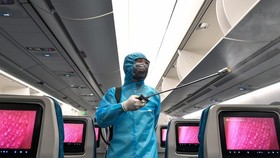 A worker cleaning and disinfecting an aircraft