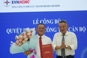 Ông Phạm Quốc Bảo trao quyết định bổ nhiệm chức danh Giám đốc Công ty Điện lực Hóc Môn cho ông Lê Quang Bình (bên trái)
