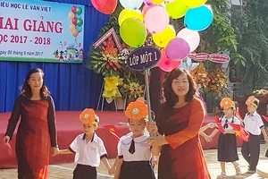 Cô Phạm Ngọc Lan, Hiệu trưởng Trường Tiểu học Lê Văn Việt, quận 9, TPHCM chào đón các em học sinh bước vào năm học mới. Ảnh: ĐÀO THỤY