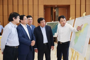 Thủ tướng Phạm Minh Chính và các đại biểu xem giới thiệu sơ đồ quy hoạch vùng Đồng bằng sông Hồng. Ảnh: VIẾT CHUNG