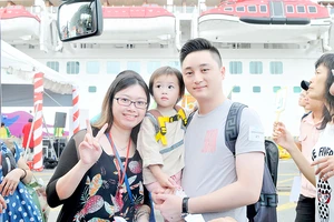 Một gia đình du khách đi tàu biển đến tham quan TPHCM. Ảnh: CAO THĂNG