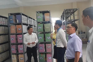 Giám đốc Sở TN-MT TPHCM Nguyễn Toàn Thắng (trái) kiểm tra công tác lưu trữ hồ sơ tại chi nhánh Văn phòng đăng ký đất đai Nhà Bè