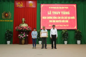 Đại diện gia đình nhận Huân chương Dũng cảm của Chủ tịch nước trao tặng cho anh Nguyễn Hữu Đốn