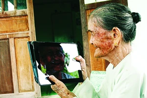 Bà mẹ Việt Nam anh hùng Võ Thị Tới nhìn chân dung mình trong iPad