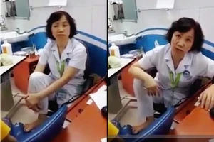 Hình ảnh bác sĩ Minh ngồi khám bệnh và nói chuyện với người nhà bệnh nhân (cắt từ clip)