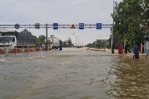 Quốc lộ 1A qua địa bàn thị xã Hương Trà bị ngập sâu khiến người và phương tiện tham gia giao thông gặp khó khăn