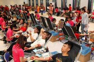 Các tình nguyện viên tham gia hiến máu trong Ngày hội Giọt hồng tri ân. Ảnh: TTXVN
