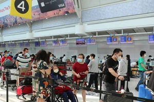 Công dân Việt Nam làm thủ tục lên máy bay về nước tại sân bay thành phố Toronto