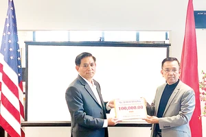 Ông David Dương, Chủ tịch Công ty CWS và VWS (bên phải) trao tặng tiền để hỗ trợ bà con miền Trung đang gặp khó khăn trong mùa bão lũ