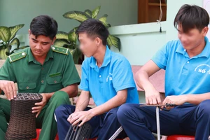 Anh Đinh Văn Tiến (trái) hướng dẫn học viên trong một buổi lao động trị liệu