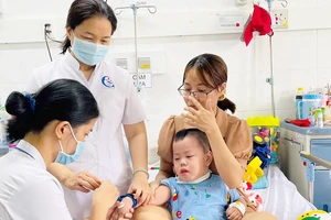BS-CKI Nguyễn Thị Tường Diễm, Trưởng khoa Nhi, Bệnh viện quận 7 (TPHCM), thăm khám cho bệnh nhi chiều 12-5. Ảnh: QUANG HUY