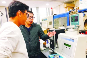 Đại diện Công ty Cổ phần Graphene Life giới thiệu máy kiểm tra độ dẻo của vật liệu graphene ở Hàn Quốc