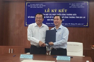 Giám đốc Sở Công thương TPHCM Phạm Thành Kiên và Giám đốc Sở Công thương Gia Lai Bùi Khắc Quang trao kết quả ký kết hợp tác ngành công thương giữa 2 địa phương. Ảnh: YẾN VŨ