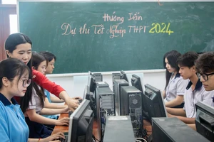 Giáo viên Trung tâm Giáo dục phổ thông (Trường Đại học Công thương TPHCM) hướng dẫn học sinh đăng ký dự thi tốt nghiệp THPT năm 2024. Ảnh: THANH HÙNG