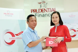 Một khách hàng có khoản vay tín chấp mới vui vẻ đón nhận quà tặng đặc biệt từ Công ty Tài chính Prudential Việt Nam nhân sự kiện kỷ niệm 10 năm thành lập