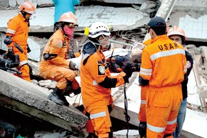 Nhân viên cứu hộ tiếp tục tìm kiếm các nạn nhân trong đống đổ nát sau thảm họa sóng thần