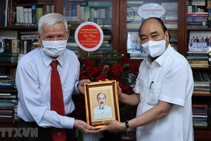 Chủ tịch nước Nguyễn Xuân Phúc thăm nhà báo Đặng Minh Phương. Ảnh: TTXVN