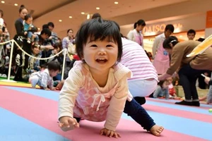 Em bé tham gia "cuộc thi bò" tại Yokohama, tỉnh Kanagawa, Nhật Bản. Ảnh: TTXVN