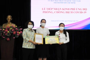 Đại diện Ủy ban MTTQ Việt Nam TPHCM tiếp nhận ủng hộ của Công ty JOY qua sự kết nối của Báo SGGP