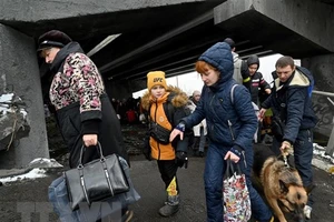 Người dân Ukraine sơ tán khỏi thành phố Irpin, phía Tây Bắc thủ đô Kiev ngày 8-3-2022. Ảnh: AFP/TTXVN
