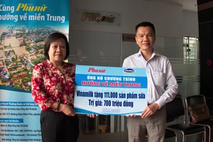 Ông Nguyễn Trung, Chủ tịch Công đoàn Công ty Vinamilk trao bảng tượng trưng 111.000 sản phẩm dinh dưỡng ủng hộ đồng bào miền Trung
