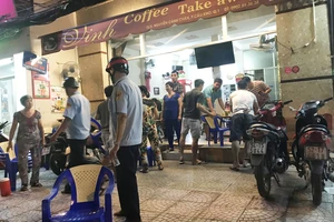 Đoàn kiểm tra phường Cầu Kho xử lý một quán cà phê lấn chiếm vỉa hè. Ảnh: KIỀU PHONG