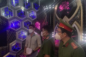 Lực lượng chức năng kiểm tra quán karaoke ở quận Gò Vấp. Ảnh: CHÍ THẠCH 