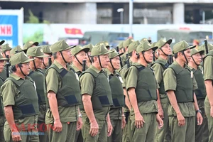 Lực lượng tham gia bảo vệ an ninh trật tự ở cơ sở tại buổi ra quân sáng 1-7. Ảnh: VIỆT DŨNG
