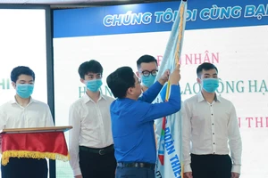 Bí thư thứ nhất Trung ương Đoàn Nguyễn Anh Tuấn thừa lệnh Chủ tịch nước gắn Huân chương lao động hạng Ba lên lá cờ của Tập đoàn Thiên Long