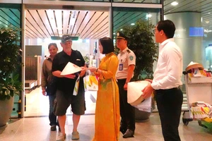 Trung tâm xúc tiến du lịch Đà Nẵng tặng quà cho những hành khách đầu tiên. Ảnh: XUÂN QUỲNH