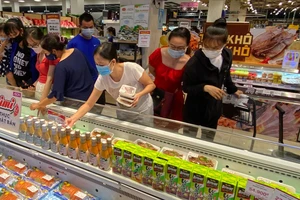 Người tiêu dùng mua thực phẩm khuyến mãi tại siêu thị Aeon Mall Bình Tân. Ảnh: CAO THĂNG