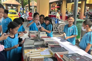 Các em nhỏ tìm mua sách trong một hội sách được tổ chức tại TPHCM. Ảnh: QUỲNH YÊN