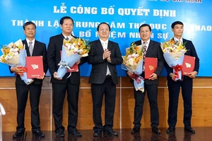 PGS.TS Huỳnh Thành Đạt trao hoa chúc mừng Ban lãnh đạo Trung tâm TDTT ĐH Quốc gia TPHCM. Ảnh: Anh Trần