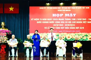 Chủ tịch Ủy ban MTTQ Việt Nam TPHCM Trần Kim Yến chúc mừng các đảng viên cao tuổi Đảng tại quận Phú Nhuận nhận Huy Đảng đợt 2-9. Ảnh: BÙI HẢI