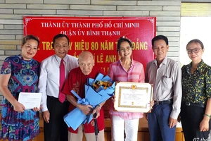 Thiếu tướng Đinh Thanh Nhàn, Phó Trưởng Ban Tổ chức Thành ủy TPHCM trao Huy hiệu 80 năm tuổi Đảng đến đồng chí Lê Anh Kim