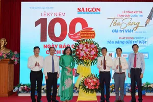 Đồng chí Huỳnh Thành Đạt, Ủy viên Trung ương Đảng, Phó trưởng Ban Tuyên giáo và Dân vận Trung ương tặng hoa chúc mừng Báo SGGP. Ảnh DŨNG PHƯƠNG