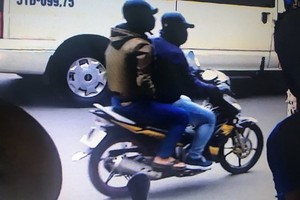 Two bank robbers detained, one on run