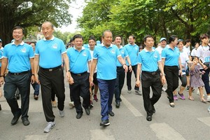 Deputy Prime Minister Truong Hoa Binh (front, fourth, left) and other people join a walk in Hanoi on June 23 (Photo: VNA)