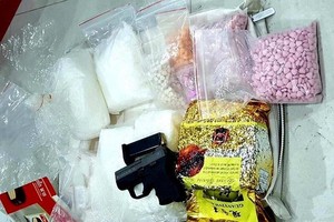 The drugs and weapon seized from the ring recently uncovered in HCM City (Source: VNA)