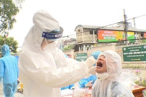 A man receives a screening swab test at Bach Mai Hospital. One more infection connected to the hospital was reported on Thursday morning. — VNA/VNS Photo